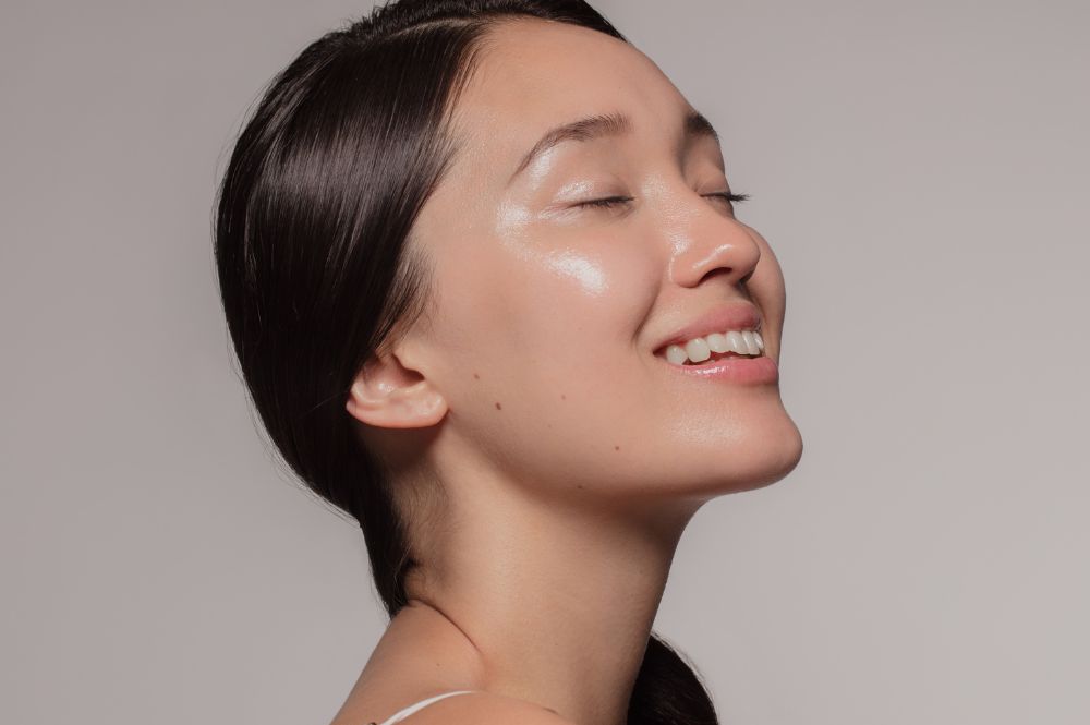 Woman showing her beautiful skin after a DiamondGlow treatment