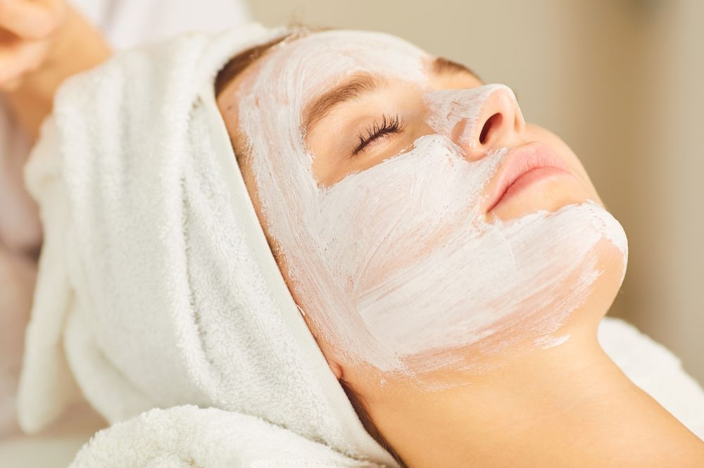 A woman receives a facial