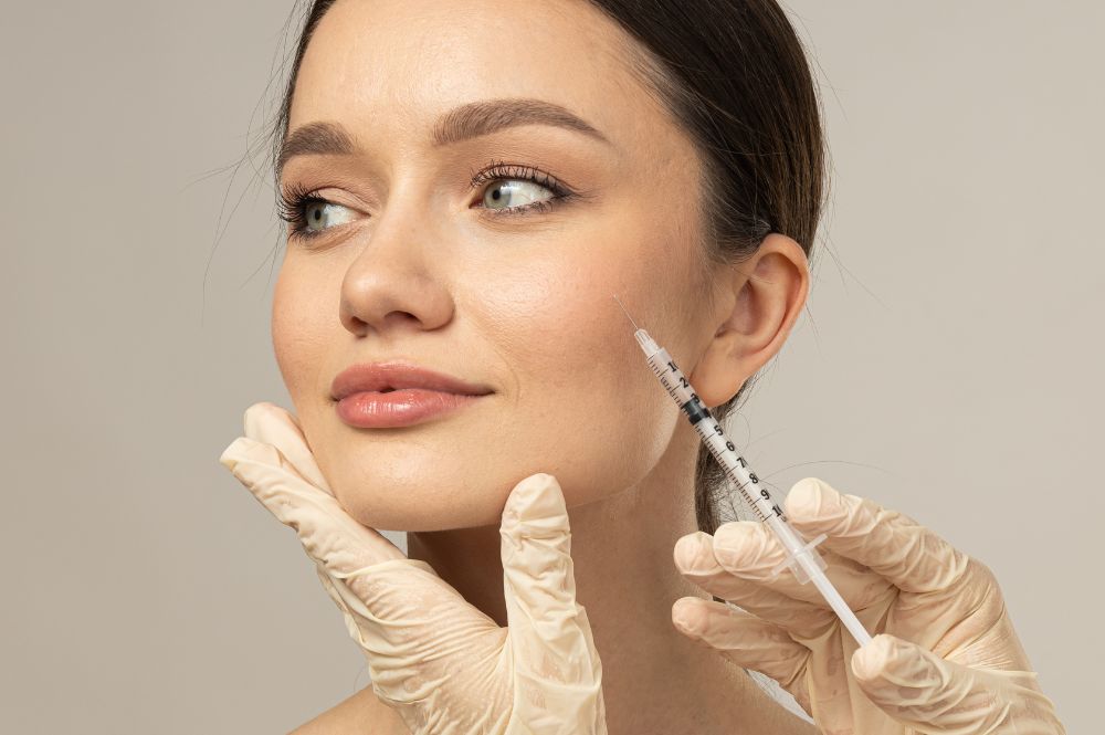 A woman receives an injectable treatment in her face